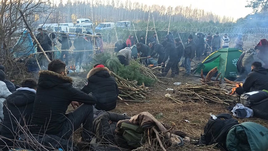 Migrants at the Belarus-Poland border make fires to keep warm on Nov. 11, 2021.