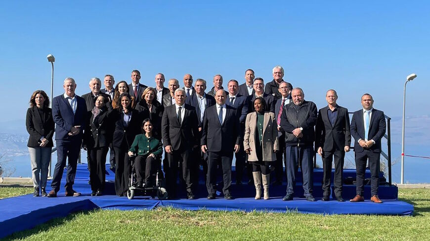 The Israeli government poses following the Dec. 26 weekly Cabinet meeting, which took place at Kibbutz Mevo Hama in the Golan Heights. 