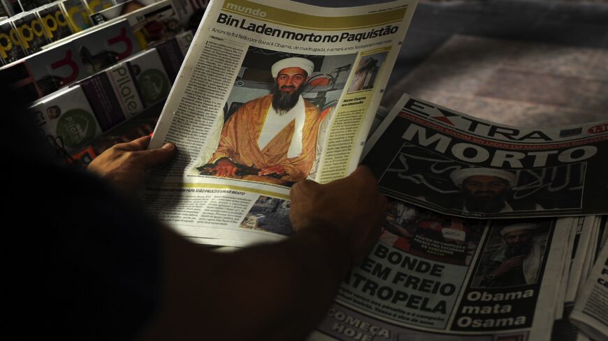 A man reads a newspaper announcing the death of Osama bin Laden, at a newsstand in Rio de Janeiro on May 2, 2011. 