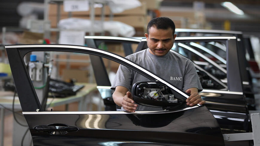 An Egyptian worker assembles car doors at a BMW factory, 6th of October City, Egypt, May 29, 2011.