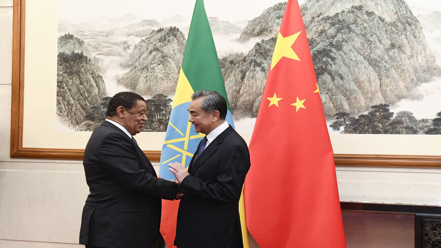 Chinese Foreign Minister Wang Yi (R) shakes hands with former Ethiopian President Mulatu Teshome during a meeting at the Diaoyutai State Guesthouse, Beijing, China, Oct. 30, 2019.