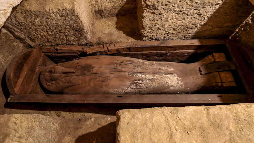 This photo shows a wooden sarcophagus discovered among many archaeological finds in 3000-year-old communal tombs dedicated to high priests, in al-Ghoreifa in Tuna al-Jabal, Minya governorate, Egypt, Jan. 30, 2020.