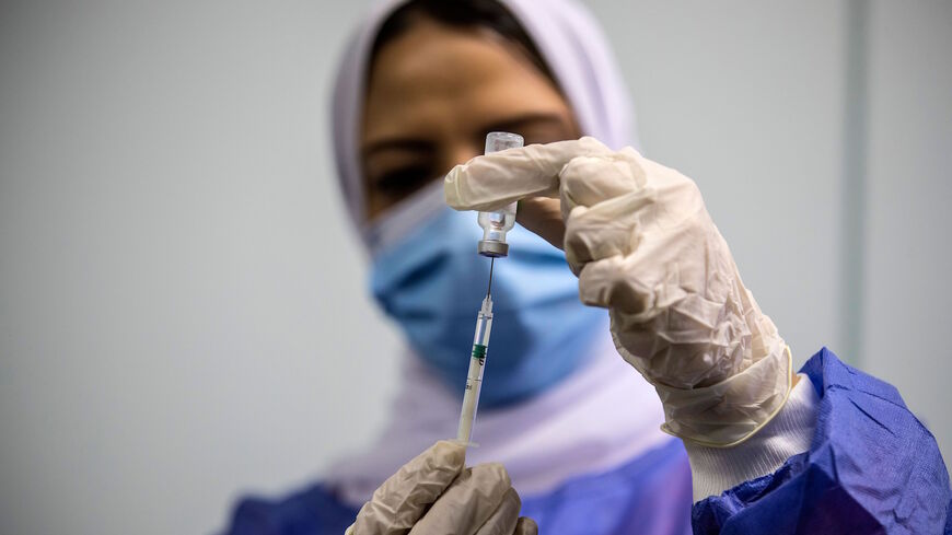 An Egyptian medical worker administers a dose of the Oxford-AstraZeneca Covid-19 vaccine (Covishield) on March 4, 2021 in Cairo on the first day of vaccination in Egypt.