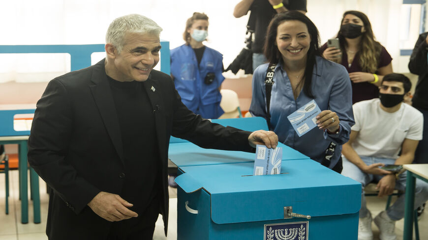 Yesh Atid party leader Yair Lapid and his wife Lihi Lapid cast their vote as Israelis head to the poll, Tel Aviv, Israel, March 23, 2021.