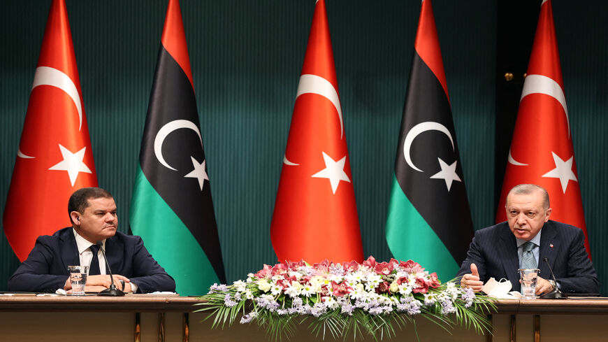 Turkish President Recep Tayyip Erdogan (R) and Libyan Government of National Accord Prime Minister Abdul Hamid Dbeibah attend a signing ceremony after their meeting at the Presidential Palace in Ankara, Turkey, April 12, 2021.