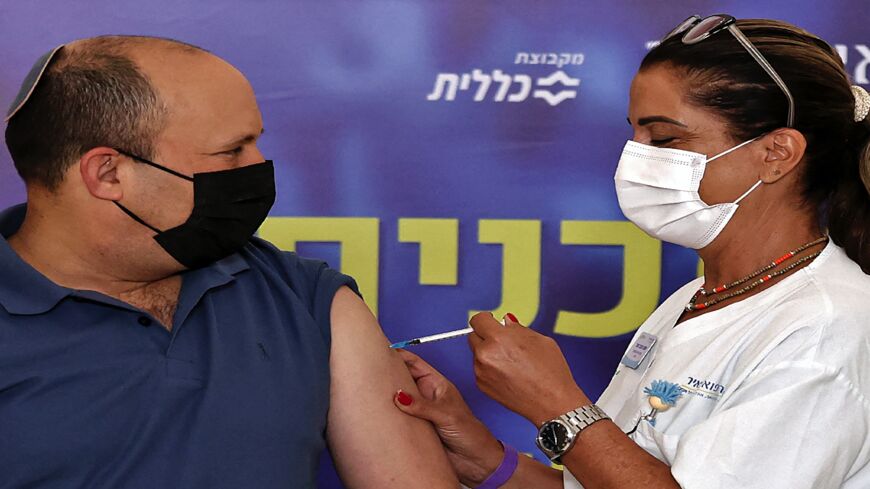 Israeli Prime Minister Naftali Bennett receives a booster shot against the coronavirus, at Meir Medical Center in Kfar Saba, on Aug. 20, 2021. 