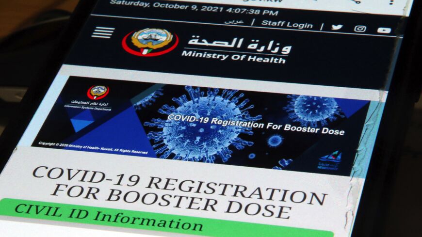This picture taken on Oct. 9, 2021, shows a view of a phone displaying the Kuwaiti Health Ministry's registration page for a COVID-19 coronavirus vaccine booster.