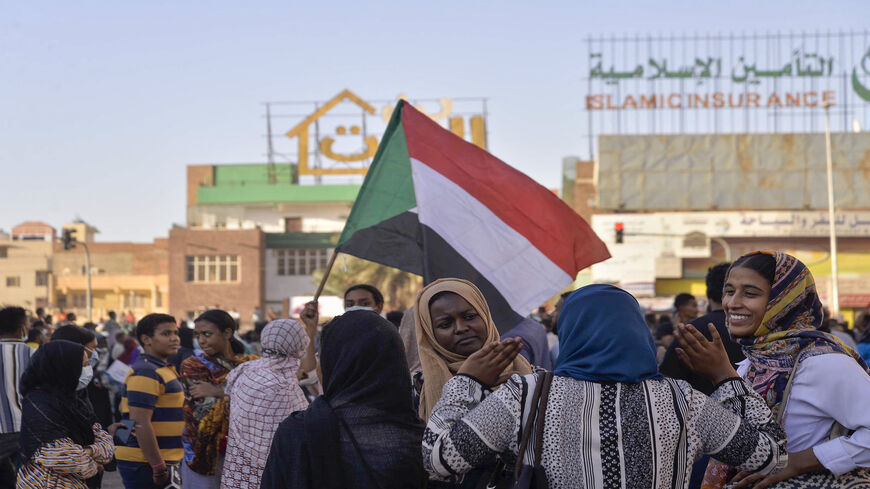 Sudanese women chat during a rally in 60th Street following a deal-signing ceremony to restore the transition to civilian rule in the country, Khartoum, Sudan, Nov. 21, 2021.