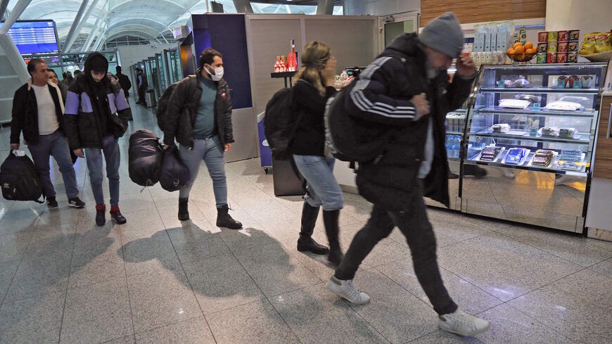 Iraqi migrants who were flown home from the Belarusian capital Minsk, arrive at the airport in Arbil, the capital of Iraq's northern autonomous Kurdish region, on Nov. 26, 2021. 