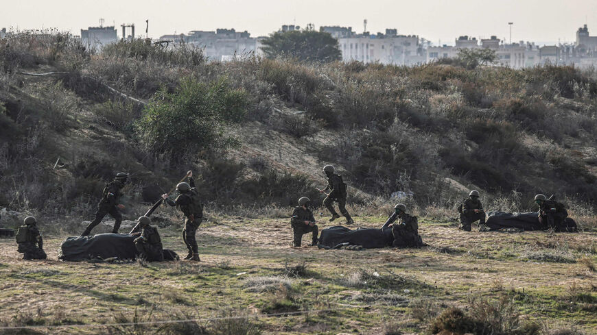 Fighters from Gaza-based armed Palestinian factions, taking part in a military exercise, shoot rockets toward the sea, at a site in Rafah, southern Gaza Strip, Dec. 29, 2021.