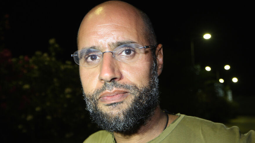 Saif al-Islam Kadhafi, son of Libyan leader Moamer Kadhafi, appears in front of supporters and journalists at his father's residential complex in the Libyan capital Tripoli in the early hours of Aug. 23, 2011.