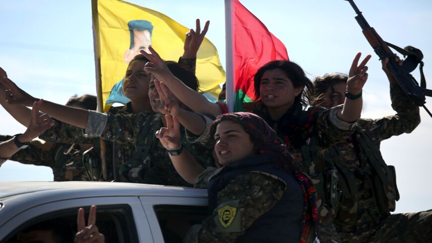 Yazidi soldiers cheer a fallen comrade on Nov. 15, 2015, near Sinjar, Iraq.