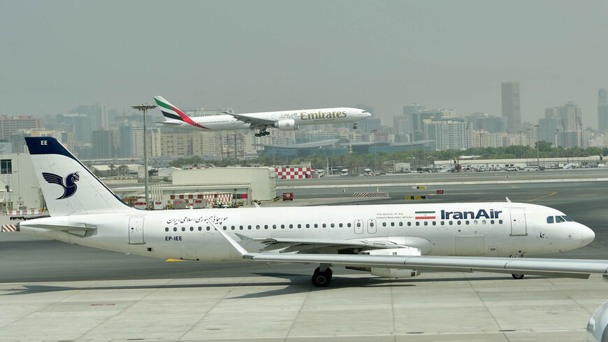 This photo shows a Emirates Boeing 777 landing while an IranAir plane is taxiing at Dubai's International Airport, Sept. 14, 2017.