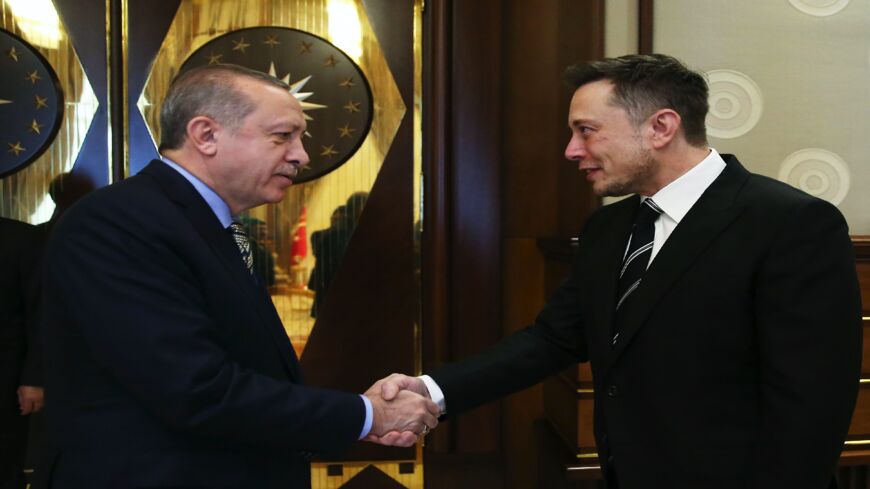 Turkish President Recep Tayyip Erdogan (L) shakes hands with founder of US aerospace manufacturer and space transport services company SpaceX Elon Musk in Ankara on Nov. 8, 2017.