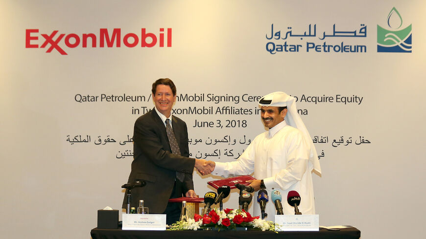 Andrew Swiger, senior vice-president of Exxon (L) shakes hand with Saad Sherida Al-Kaabi, president and CEO of Qatar Petroleum after signing an agreement, Doha, Qatar, June 3, 2018.