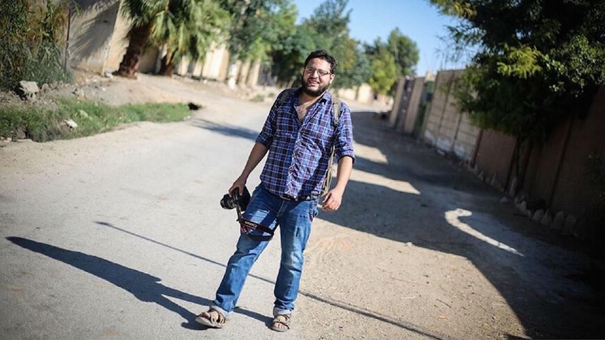 Anas al-Kholi with his camera near Damascus.