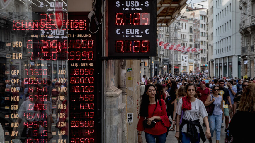 People walk past a currency exchange office on Aug. 29, 2018 in Istanbul, Turkey. 