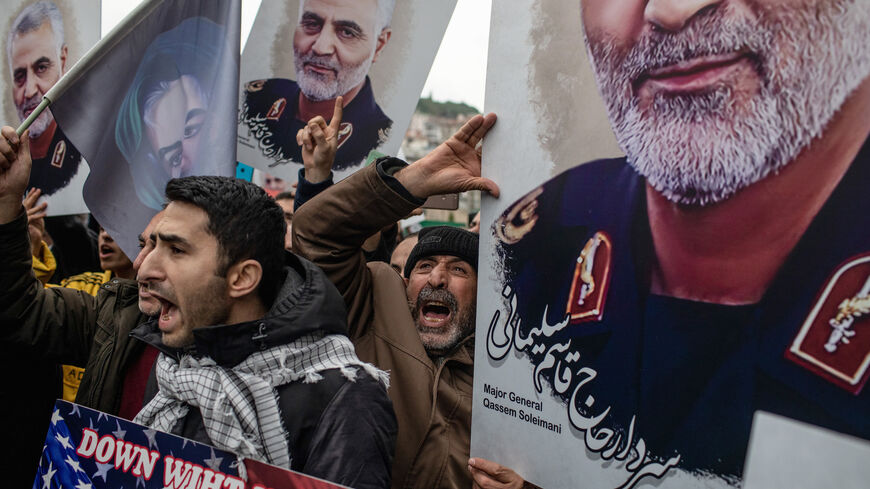People hold posters showing the portrait of Iranian Revolutionary Guard Major General Qassem Soleimani and chant slogans during a protest outside the US Consulate on Jan. 5, 2020 in Istanbul, Turkey. 