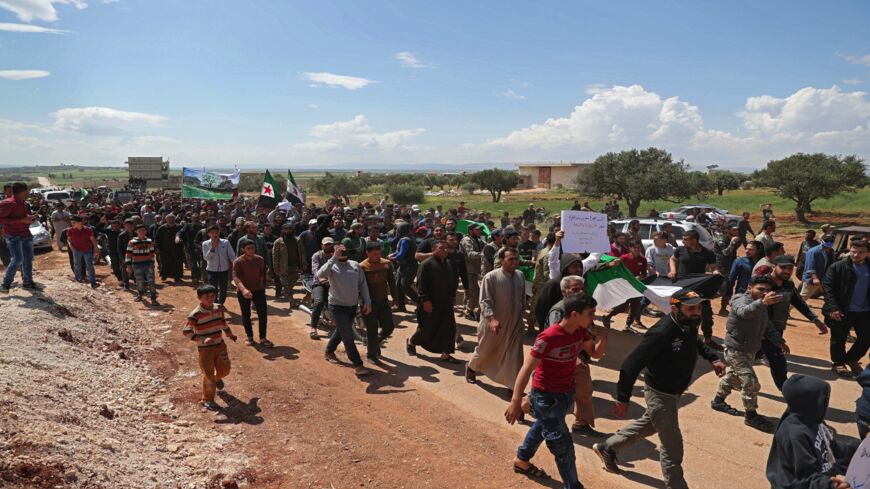 Syrian demonstrators gather during a protest in Syria's Idlib province on May 1, 2020, to protest a reported attack by Hayat Tahrir al-Sham.