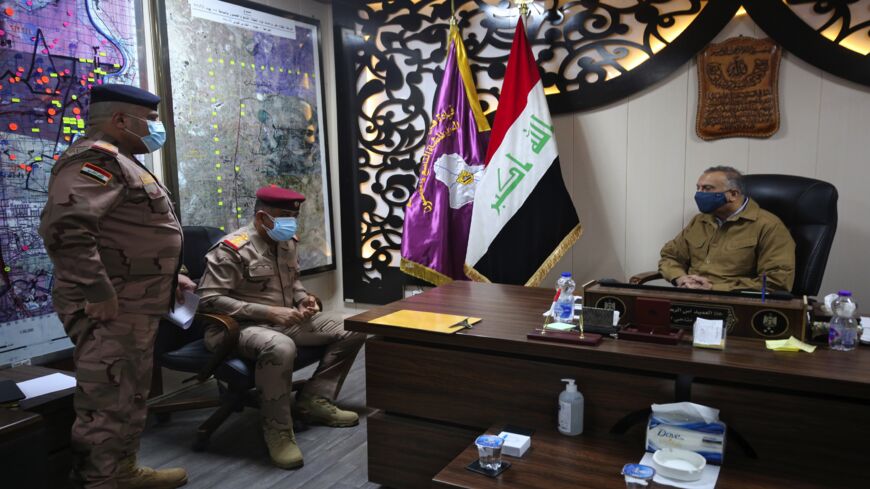 Iraq's Prime Minister Mustafa al-Kadhimi (R) visits the army headquarters in Tarmiya, 35 kilometers north of Baghdad, on Feb. 20, 2021.