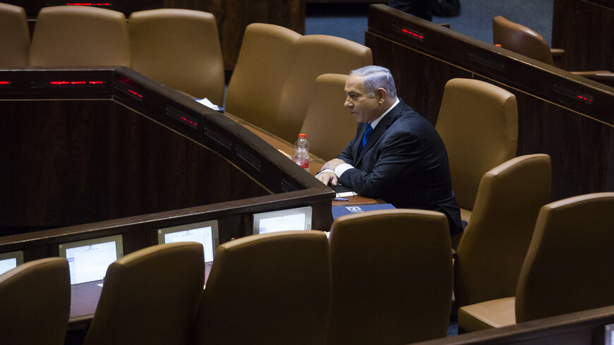 Israeli Prime Minister Benjamin Netanyahu sits in the Knesset before parliament votes to approve the new government, Jerusalem, June 13, 2021.