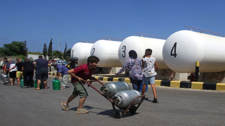 Lebanese wait to fill their gas cylinders in the southern city of Sidon amidst a deepening economic crisis, on Aug. 10, 2021.