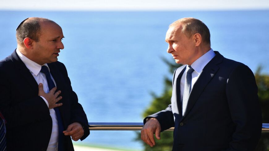 Russian President Vladimir Putin (R) speaks with Israeli Prime Minister Naftali Bennett during their meeting in Sochi on Oct. 22, 2021.