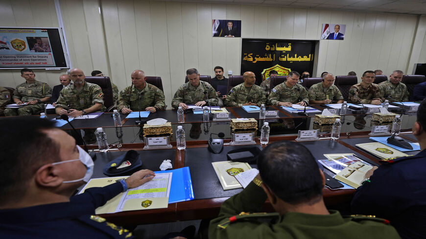 NATO Mission Iraq Commander Lt. Gen. Michael Lollesgaard (3rd-R behind) and Commander of the US-led international coalition against the Islamic State Maj. Gen. John W. Brennan (4th-R behind) attend a meeting of Iraqi and coalition commanders at the Joint Operations Center, Baghdad, Iraq, Dec. 9, 2021.