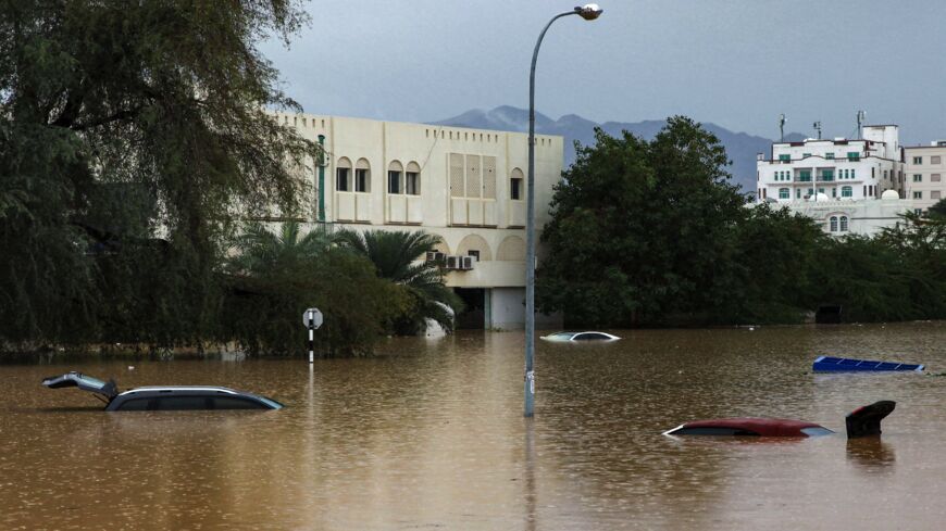 This picture taken on Jan. 4, 2022, shows a view of flooded cars in a parking lot outside a shopping center in Oman's capital, Muscat.