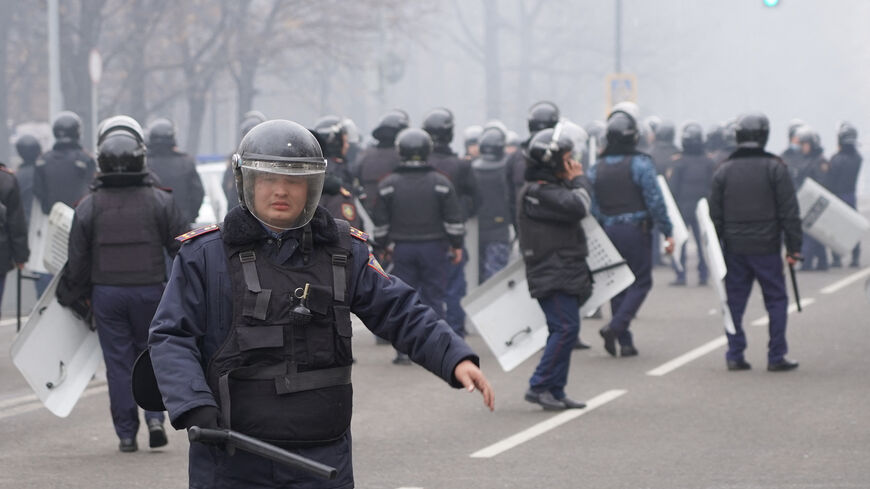 Riot police officers patrol in a street as unprecedented protests over a hike in energy prices spun out of control in Almaty on Jan. 5, 2022.