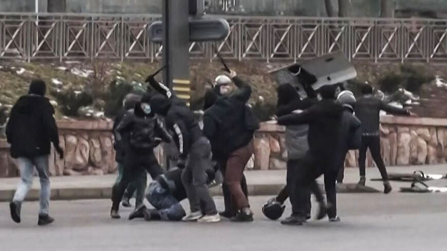 A frame grab taken on January 6, 2022 from an AFPTV video made on January 5, 2022, shows protesters clashing with Kazakstan's security forces during a demonstration in the country largest city Almaty as unprecedented unrest in the Central Asian nation spins out of control due to a hike in energy prices. 