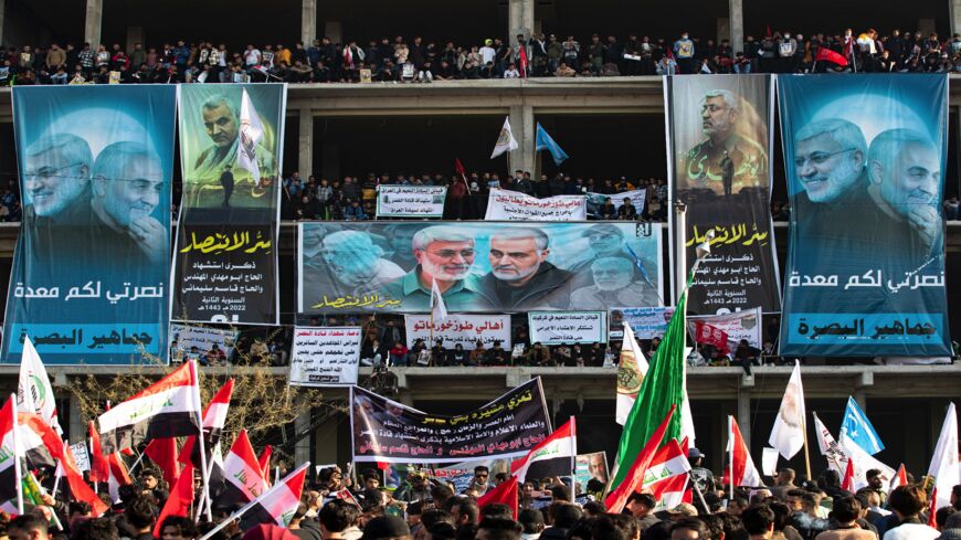 A crowd gathers to mark the second anniversary of the killing of Qasem Soleimani and Abu Mahdi al-Muhandis, in the southern Iraqi city of Basra, on Jan. 8, 2022. 
