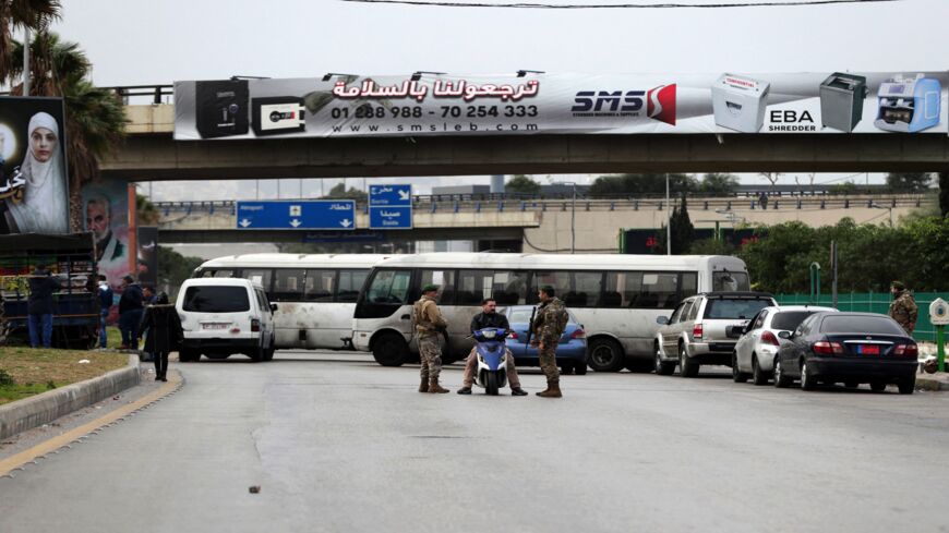 Buses block a road leading to Beirut Rafic Hariri International Airport during a strike by public transport and workers unions over the economic crisis, on Jan. 13, 2022.