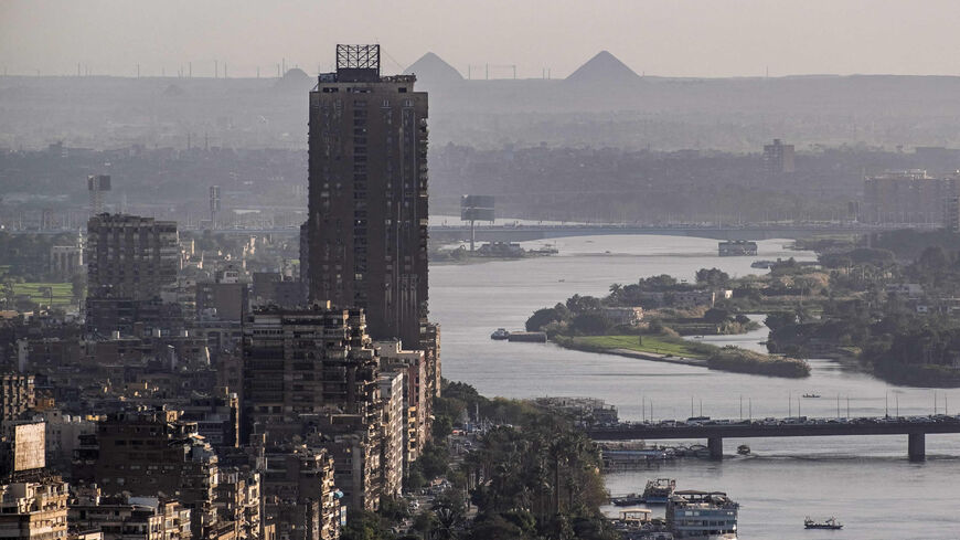 The Cairo Tower is see along the skyline of the Nile River island of Manial al-Roda (L) in Egypt's capital Cairo and its twin city of Giza (R), with the background showing (L to R): the step pyramid of Djoser, and the Bent and Red pyramids of Sneferu, Egypt.