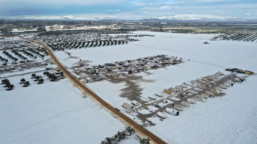 An aerial picture shows a camp for internally displaced people covered in snow, Azaz, in the rebel-controlled northern countryside of Aleppo province near the border with Turkey, Syria, Jan. 19, 2022.