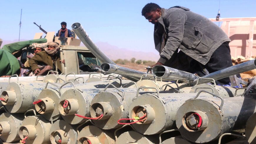Yemeni pro-government fighters surround ordnances removed from the district of Harib on Jan. 25, 2022.