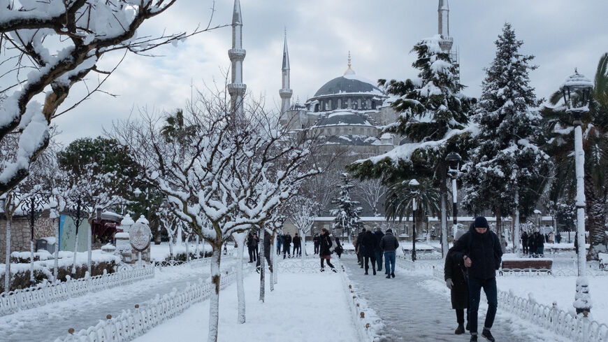 People walk through snow in front of the Blue Mosque in the Sultanahmet District on Jan. 25, 2022 in Istanbul, Turkey. 
