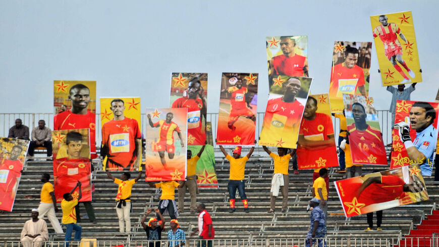 Sudan's Al-Merrikh club fans hold up images of team players as they gather to watch their team play against Congo's AC Leopards during the CAF Confederation Cup semi-final soccer match at the Merreikh Stadium, Khartoum, Sudan, Nov. 10, 2012.