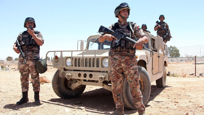 Jordanian soldiers stand guard near their vehicle as they secure the area near the Al-Karameh border point with Iraq on June 25, 2014 as Jordan reinforced its border with Iraq after Sunni Arab militants overran a crossing with Syria. 