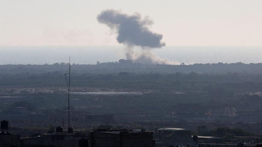 A picture taken from the Rafah border of the southern Gaza Strip with Egypt shows smoke billowing in the northern Sinai Peninsula, Egypt, July 16, 2015. The Islamic State said it carried out a missile attack on an Egyptian navy vessel off northern Sinai.