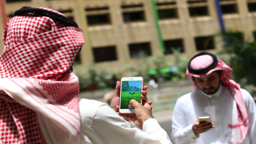 Saudi men play with the Pokemon Go application on their mobiles in the capital, Riyadh, on July 17, 2016. 