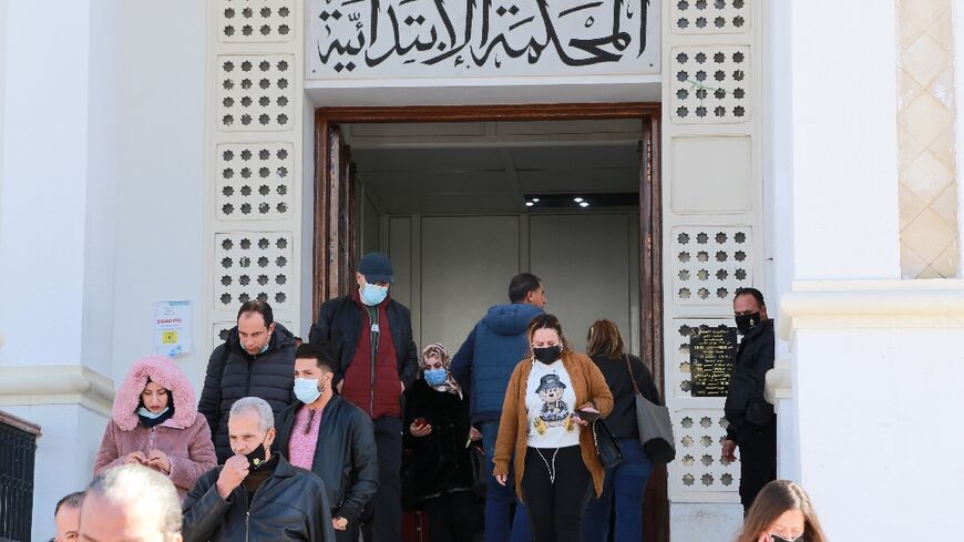 Tunisian citizens and lawyers leave a court in the governorate of Ariana after the announcement of the judges' strike