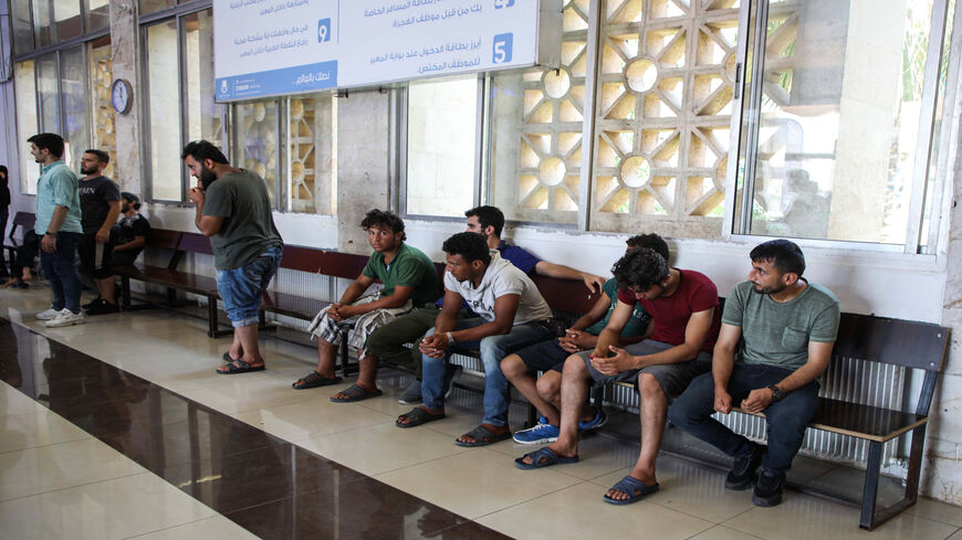 Incoming Syrian refugees who were suddenly deported from Turkey await to register with officials as they reenter Syria, at the Bab al-Hawa crossing between Turkey and Syria's northwestern Idlib province, July 24, 2019.