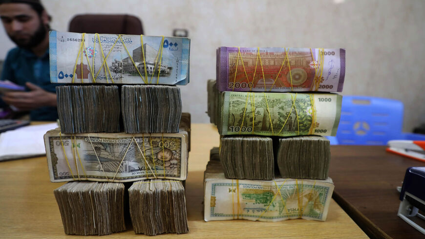 Syrian pounds are pictured at a currency exchange shop in the town of Sarmada, in northwestern Idlib province, Syria, June 15, 2020.