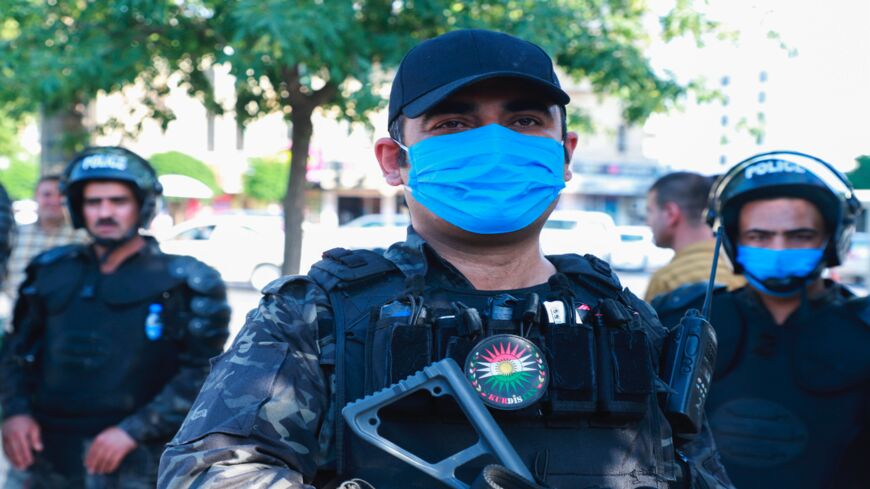 Kurdish riot police stand guard during a demonstration to denounce a Turkish assault in northern Iraq in Sulaimaniya on June 18, 2020.