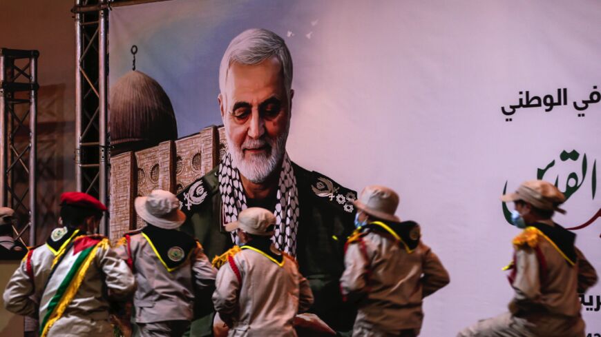 Palestinian scouts take part in a ceremony marking the first anniversary of the killing of IRGC commander Qasem Soleimani (portrait), Gaza City, on Jan. 4, 2021.