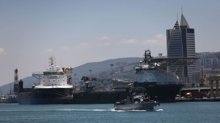 Cargo ships are moored along a dock at the port of Haifa, Israel, June 24, 2021.