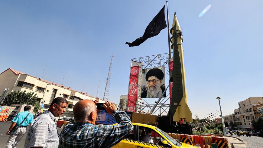 A Shahab-3 surface-to-surface missile is displayed next to a portrait of Iranian Supreme Leader Ayatollah Ali Khamenei at a street exhibition by Iran's army and paramilitary Revolutionary Guard force to celebrate "Defence Week", marking the 41th anniversary of the start of 1980-88 Iran-Iraq war, at the Baharestan Square in Tehran, on Sept. 25, 2021.