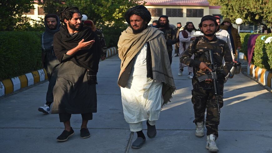 Taliban head of the Nangarhar intelligence services Dr. Bashir (C) walks inside the provincial intelligence compound in Jalalabad on Dec. 12, 2021. 