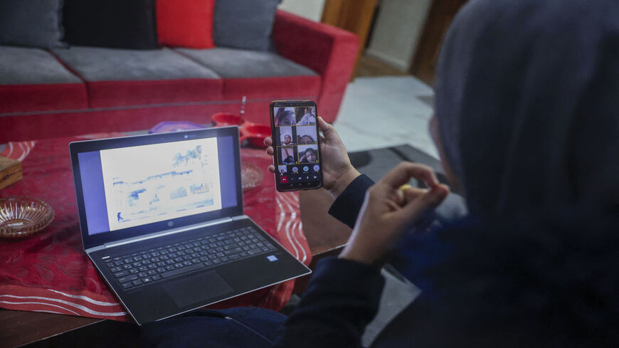Palestinian school teacher Jihad Abu Sharar gives lessons online from her home, after a decision by the minister of education to close schools and kindergartens following a surge in coronavirus cases, Dura village, the West Bank, Feb. 3, 2022.